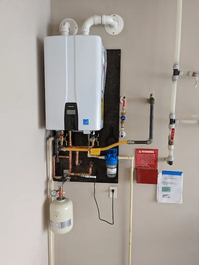 Professional plumber installing copper piping in a Orangetown home